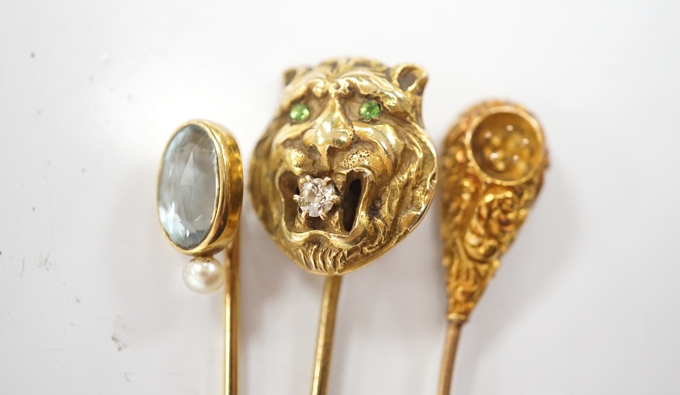 A collection of six assorted mainly early 20th century stick pins including tiger's head set with diamond and green garnets, 68mm. Condition - poor to fair